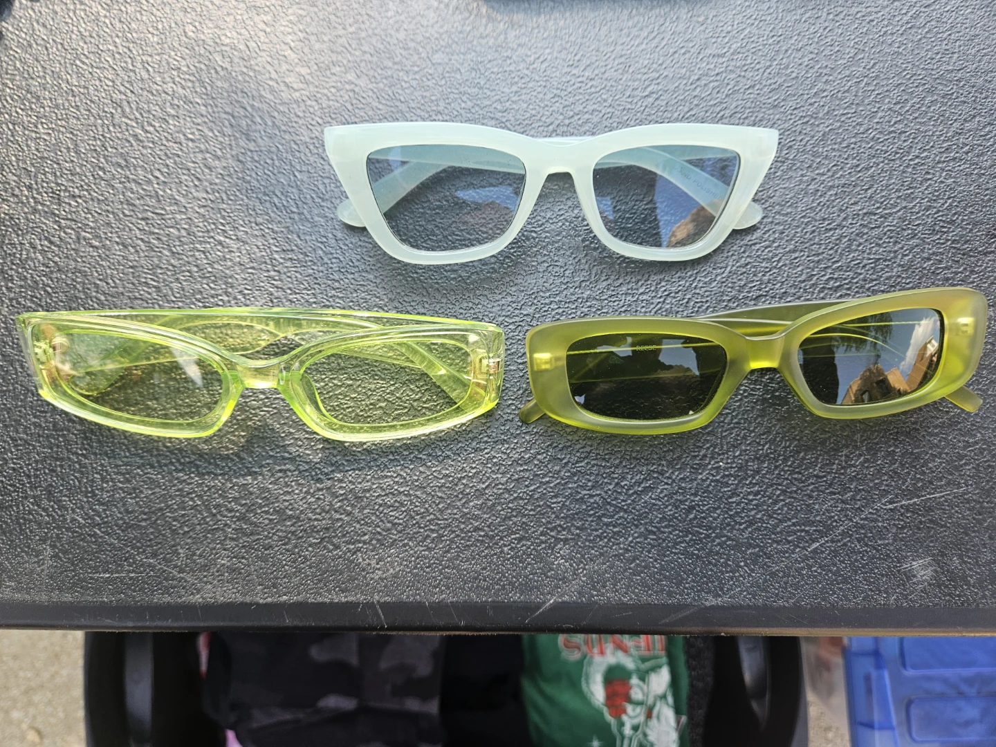 Three pairs of fashion sunglasses in green and white