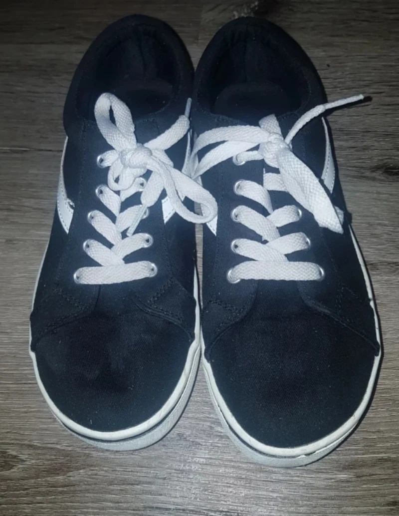 Black canvas sneakers with white laces