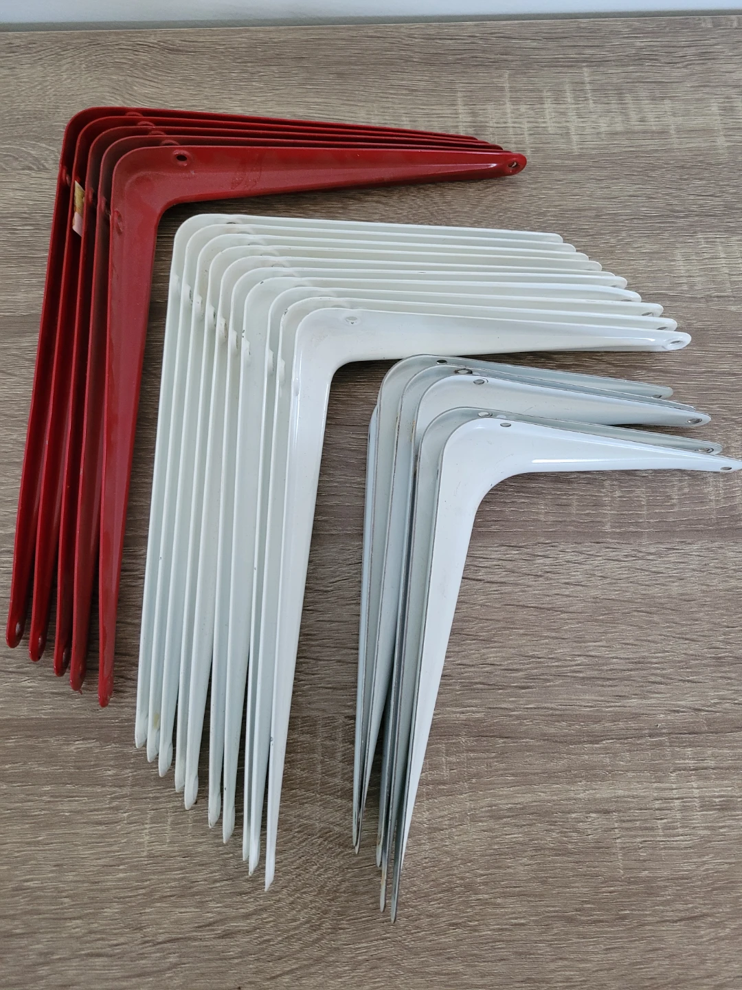 Metal shelf brackets in red, white and grey