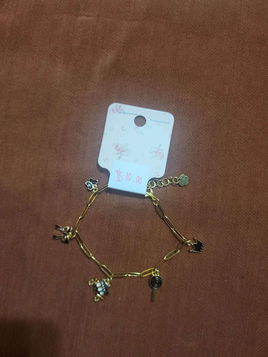 Gold-tone charm bracelet with various charms