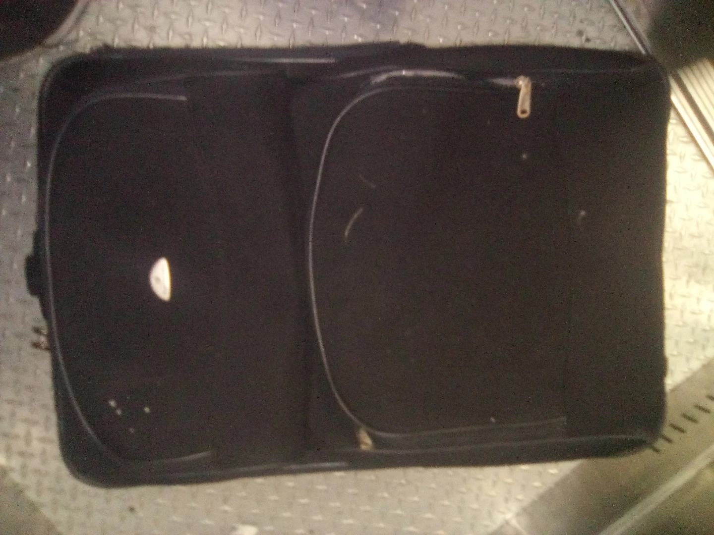 Black softshell suitcase with Canada tag