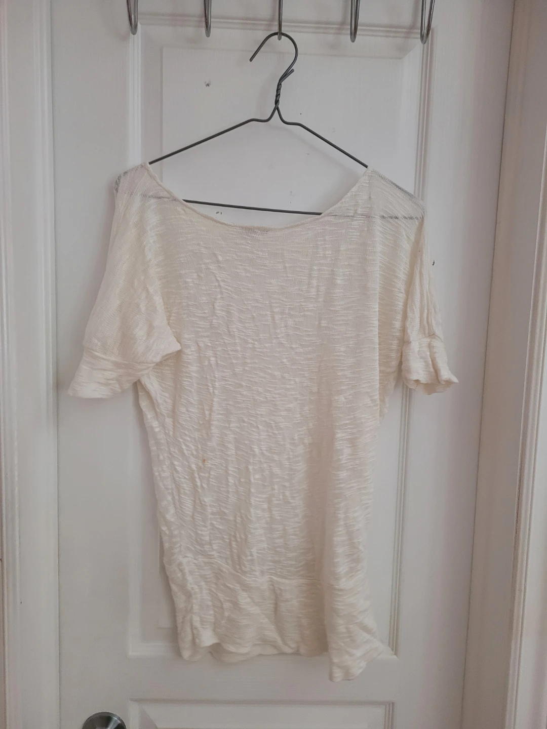 Cream coloured short sleeve knit top