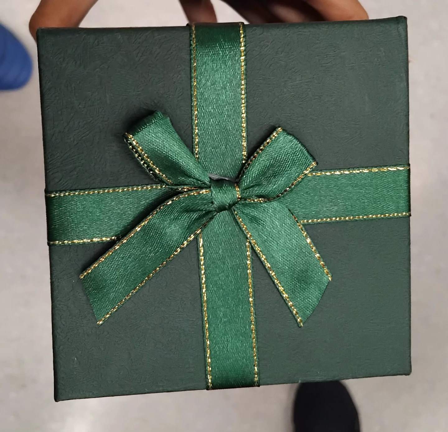 Dark green gift box with ribbon