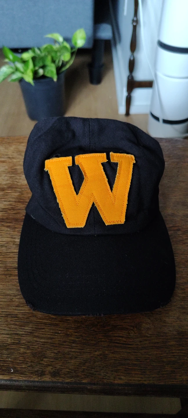 Black baseball cap with orange "W" logo