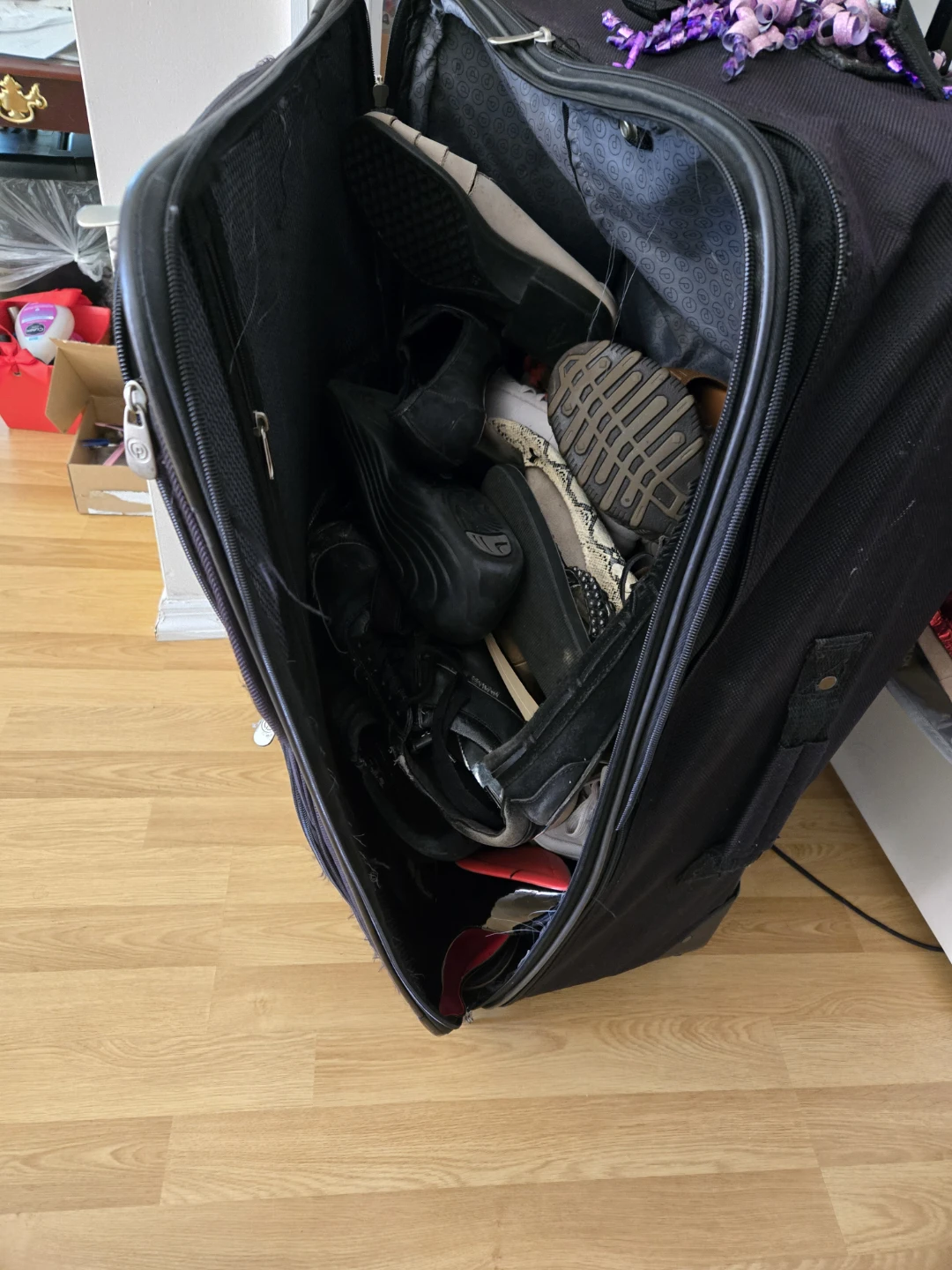 Black Rolling Suitcase full of shoes