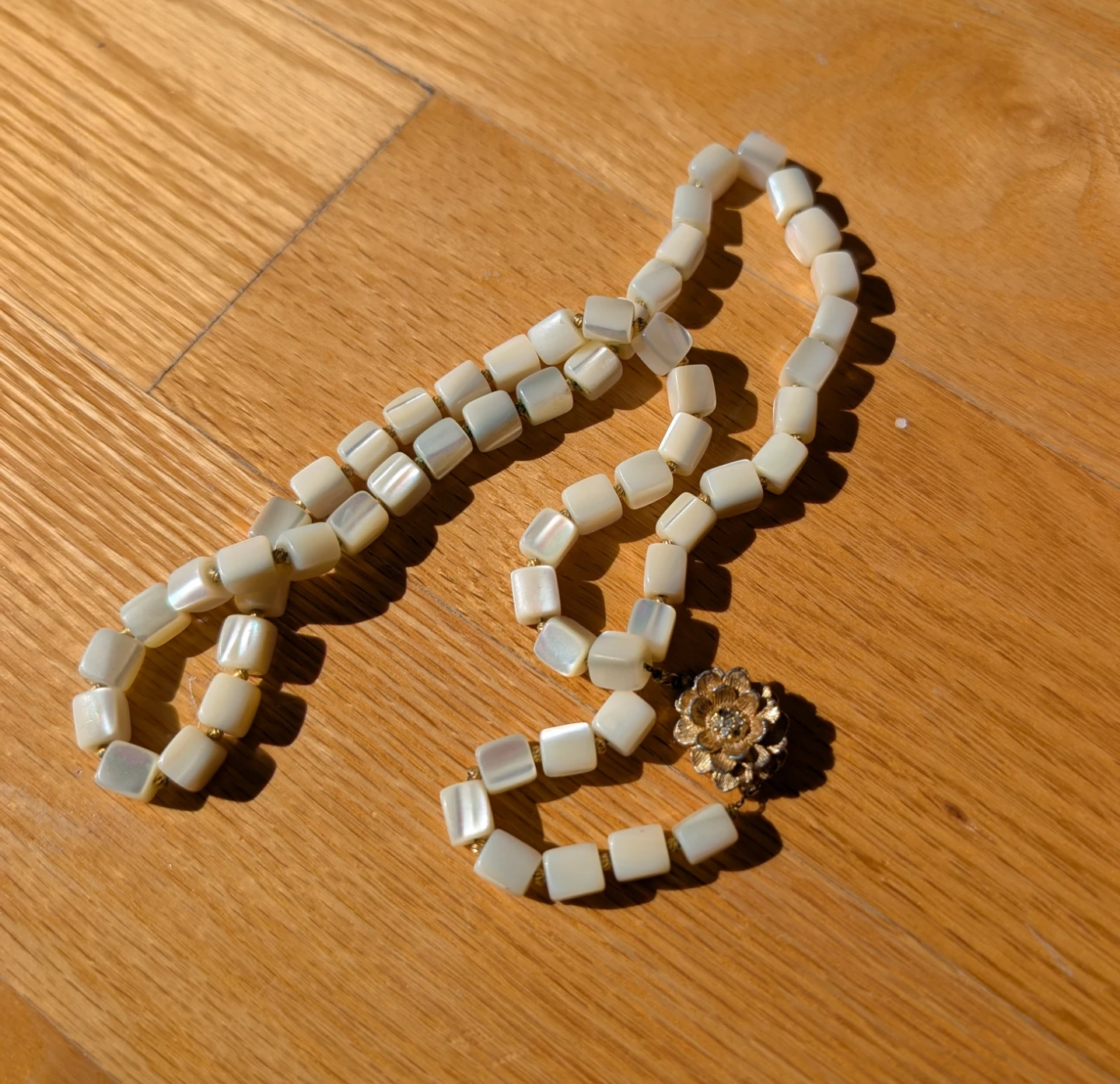Vintage Iridescent white beaded necklace with gold flower