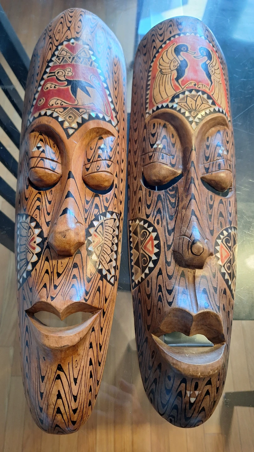 Two decorative hand carved wooden masks