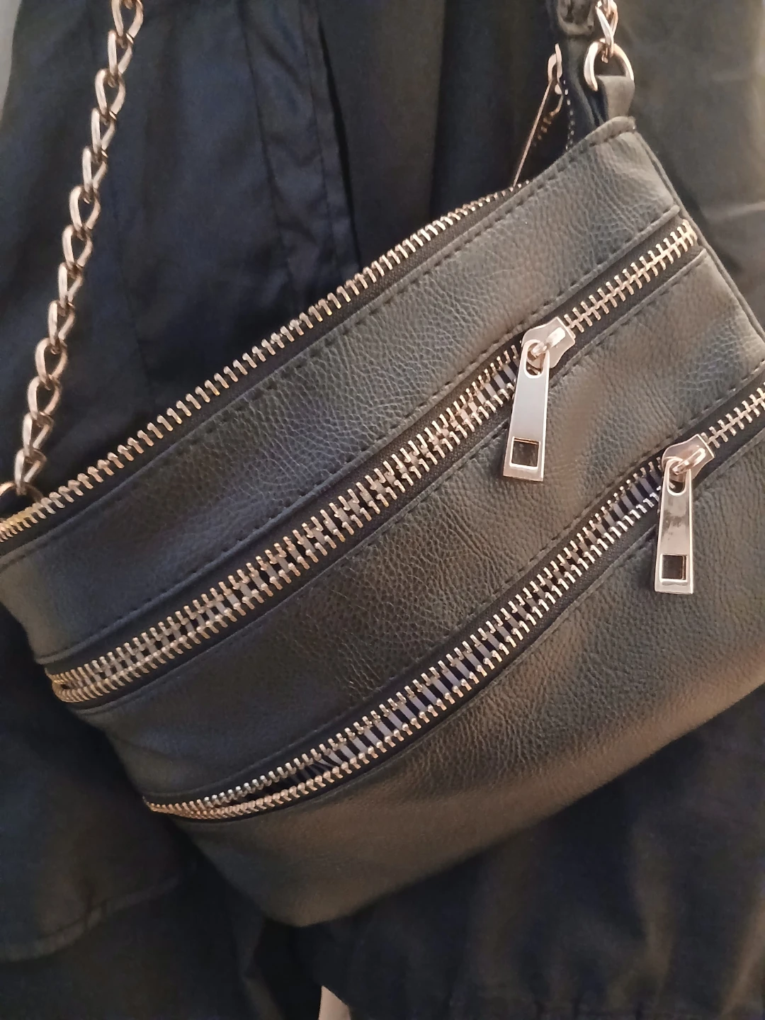 Black faux leather crossbody bag with chain strap
