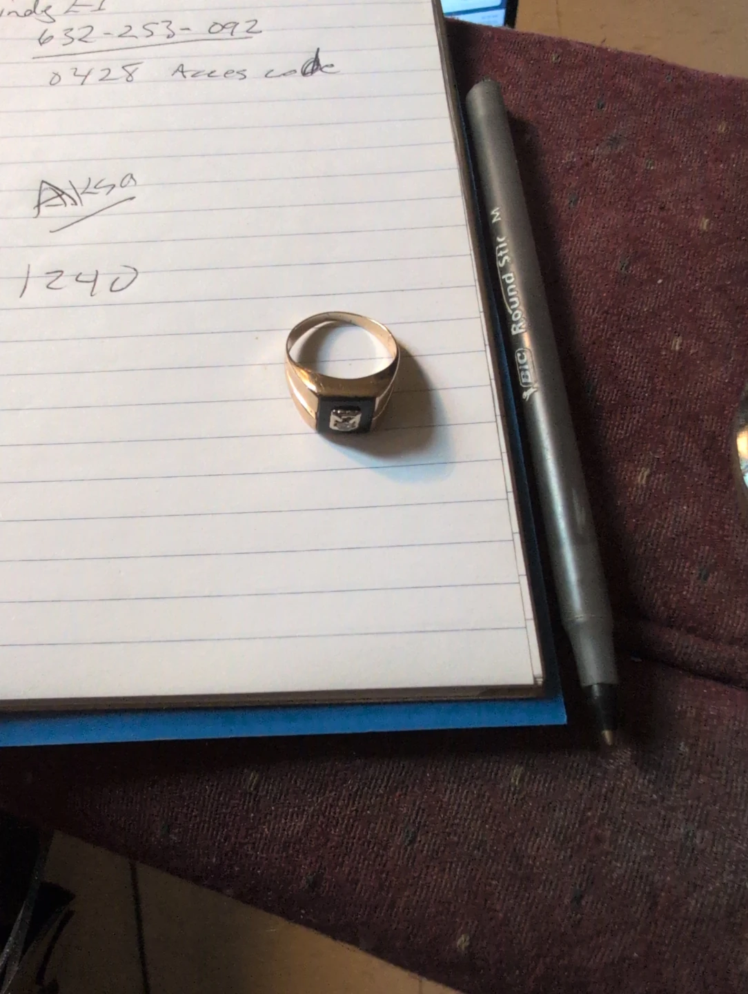 Gold signet ring with black stone and diamond accent