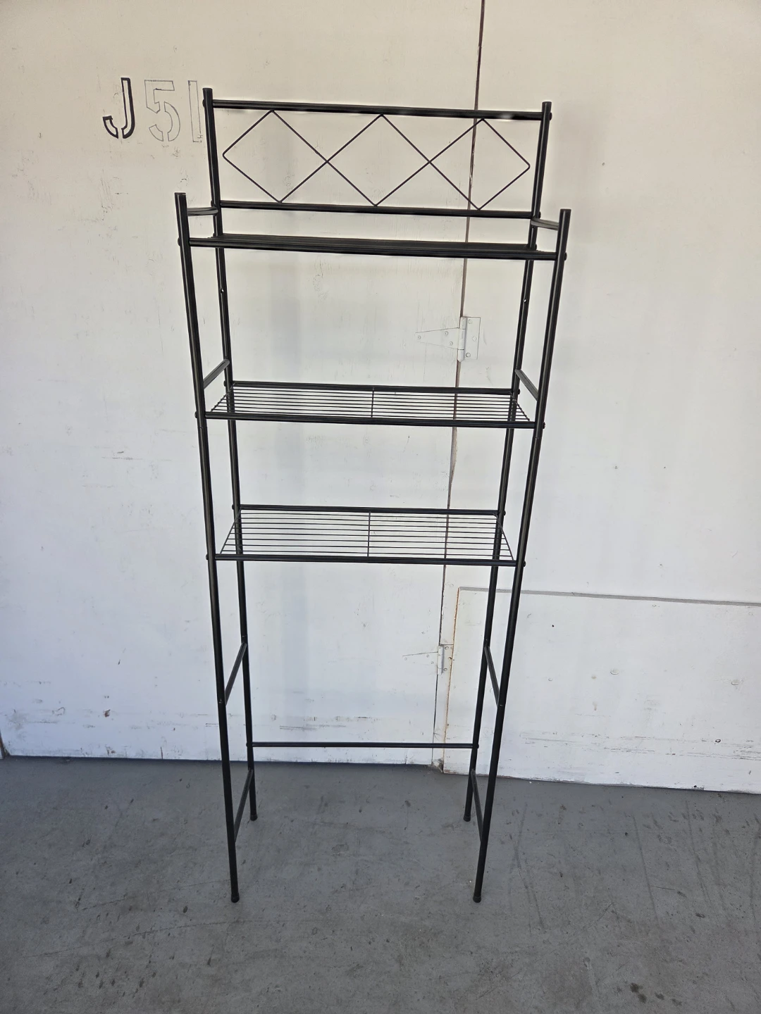 Black metal over-the-toilet storage shelf