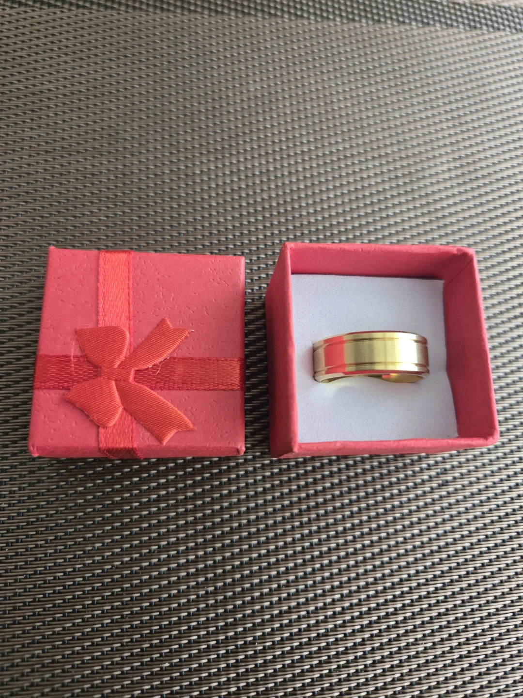 Gold coloured ring in gift box