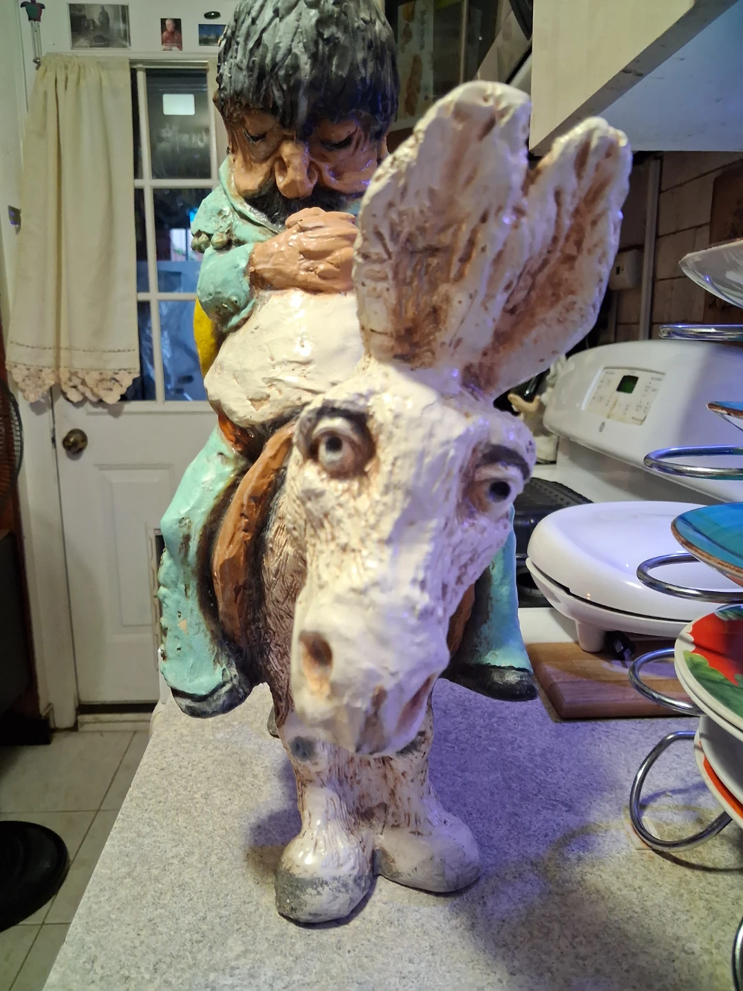 Figurine of a man riding a donkey