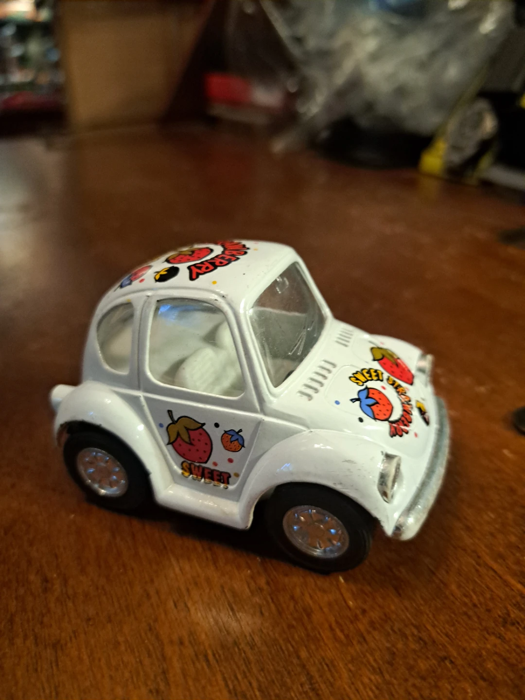 White toy car with strawberry "Sweet" decal