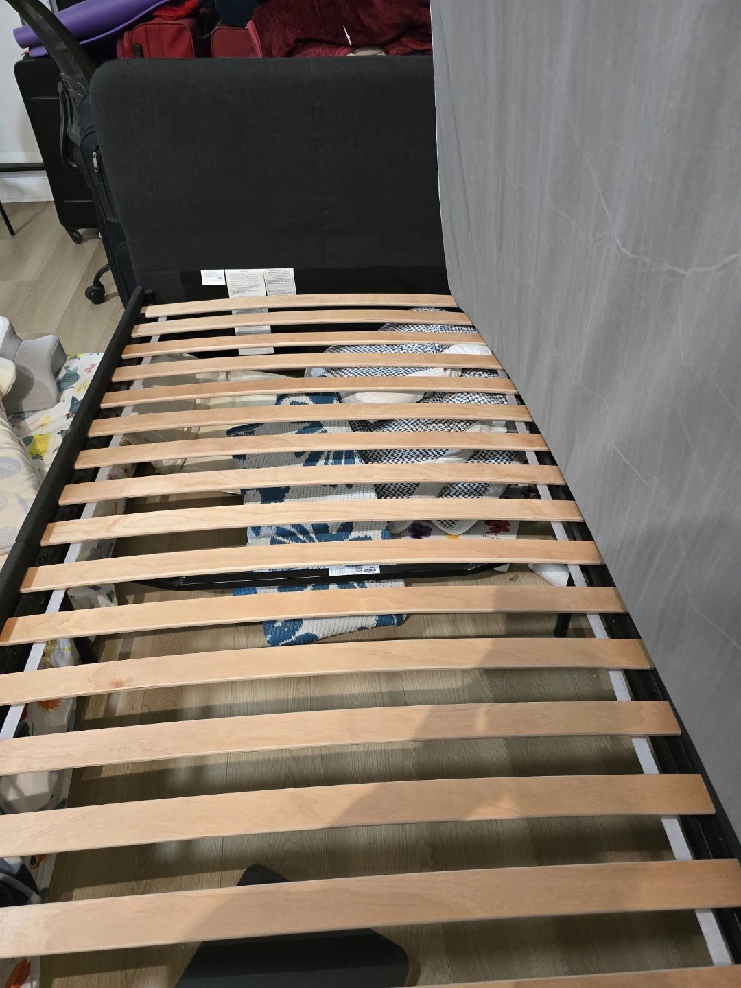 IKEA slattum Black upholstered bed frame with wood slats