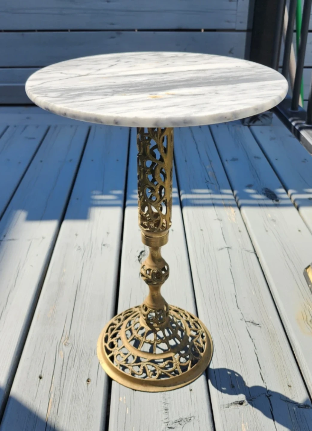 vintage side table features a white marble top with an ornate