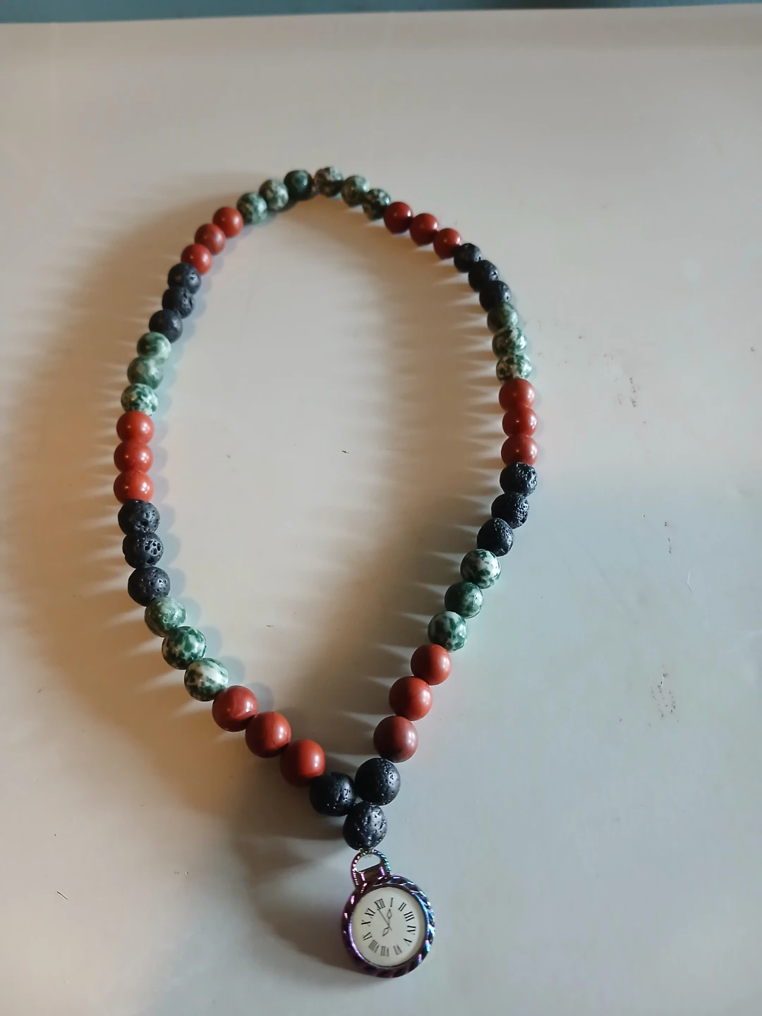 Beaded necklace with clock pendant