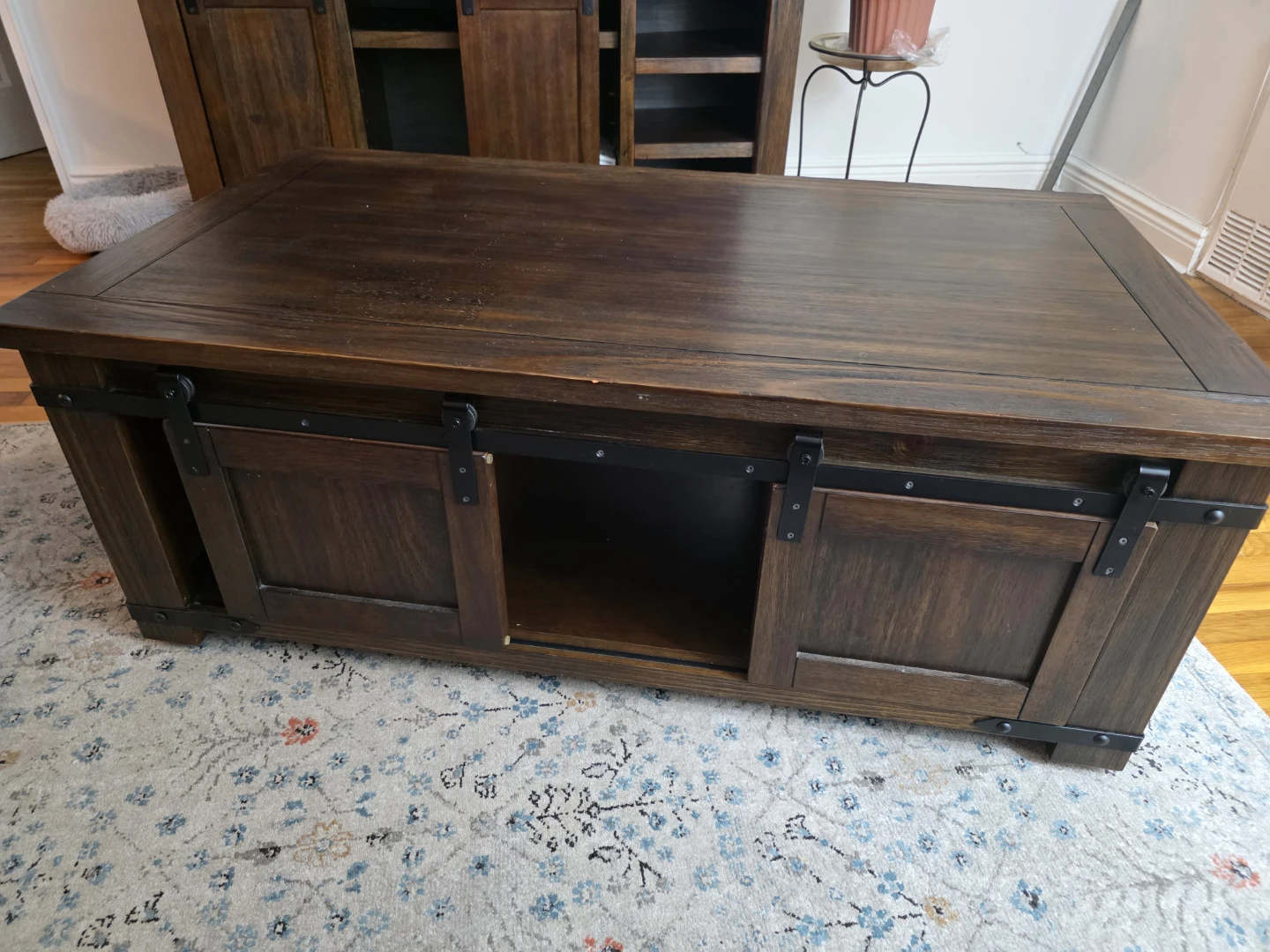 On wheels: Dark Wood Coffee Table with Sliding Doors.