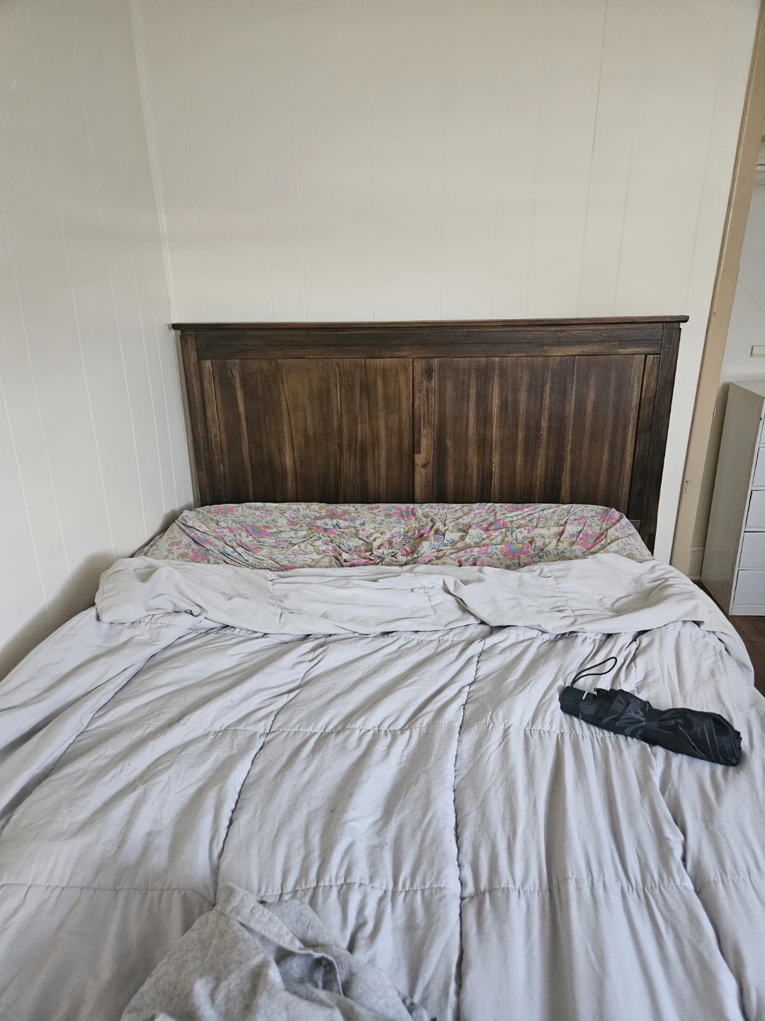 Full sized bed frame with box spring and wooden headboard