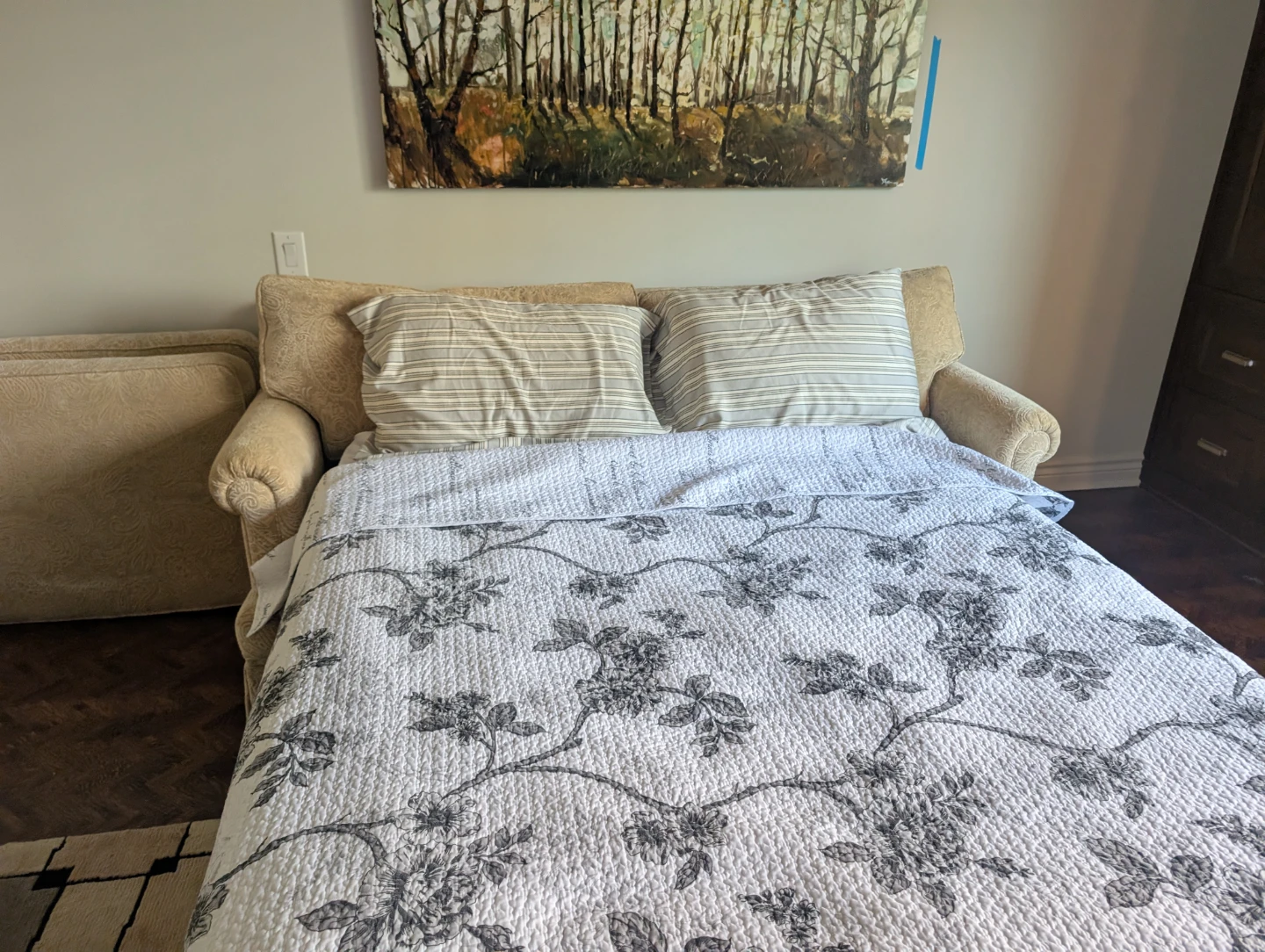 Beige Sofa Bed with Floral Duvet