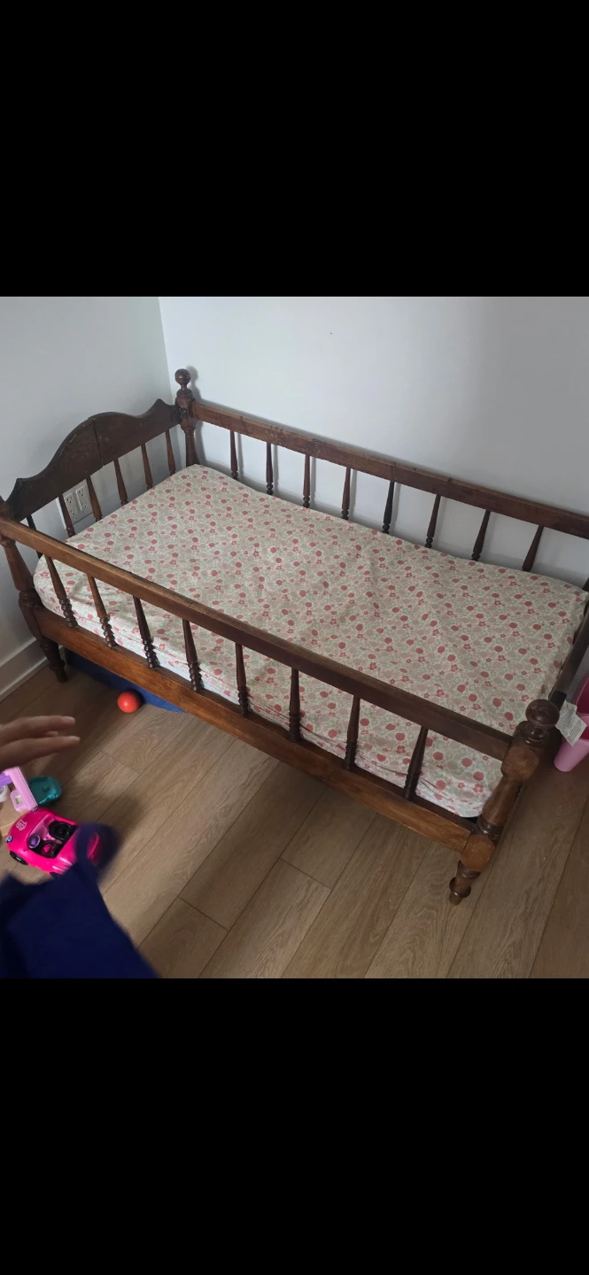 Wooden toddler bed  with floral mattress