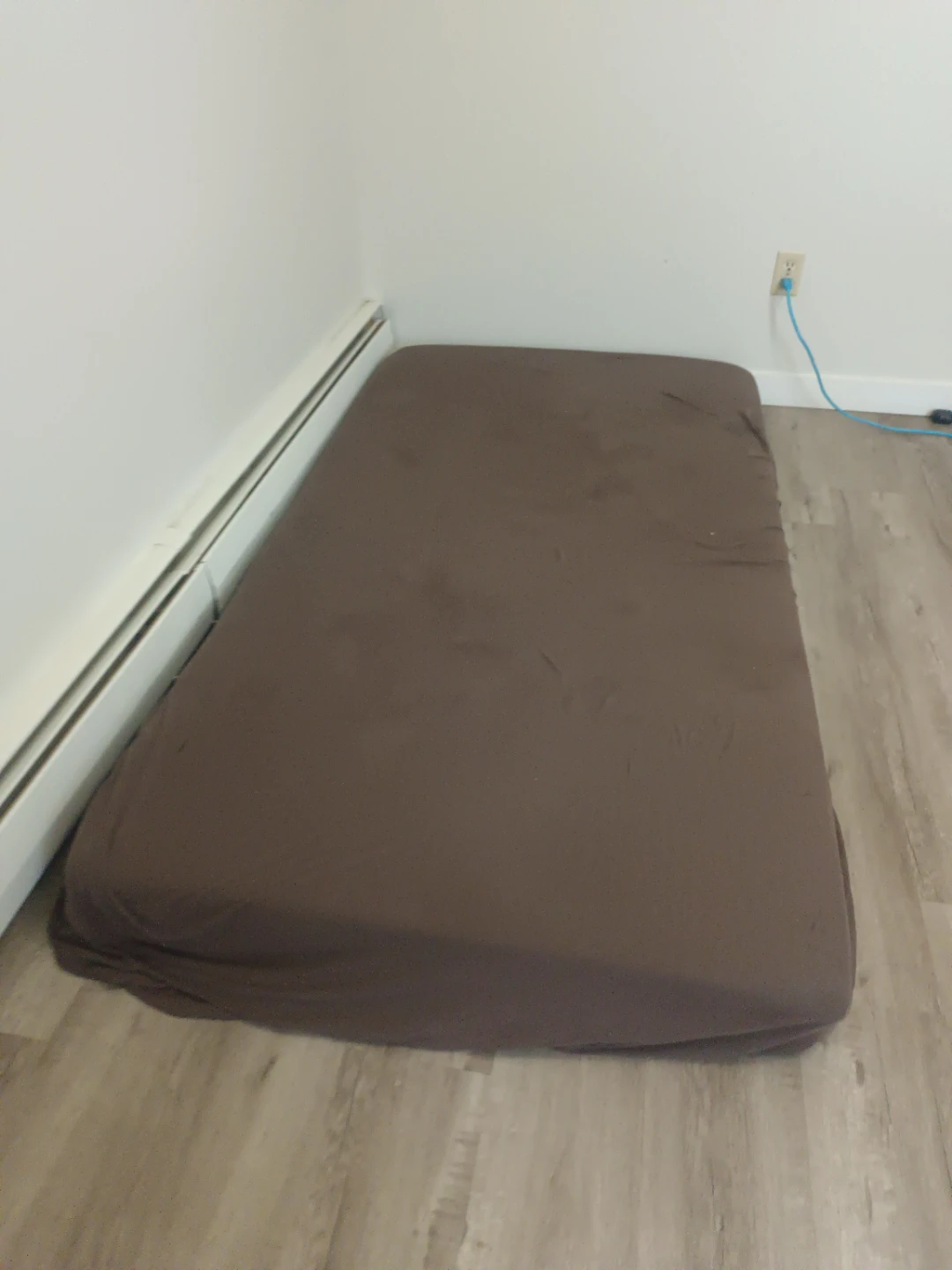 Brown mattress with fitted sheet