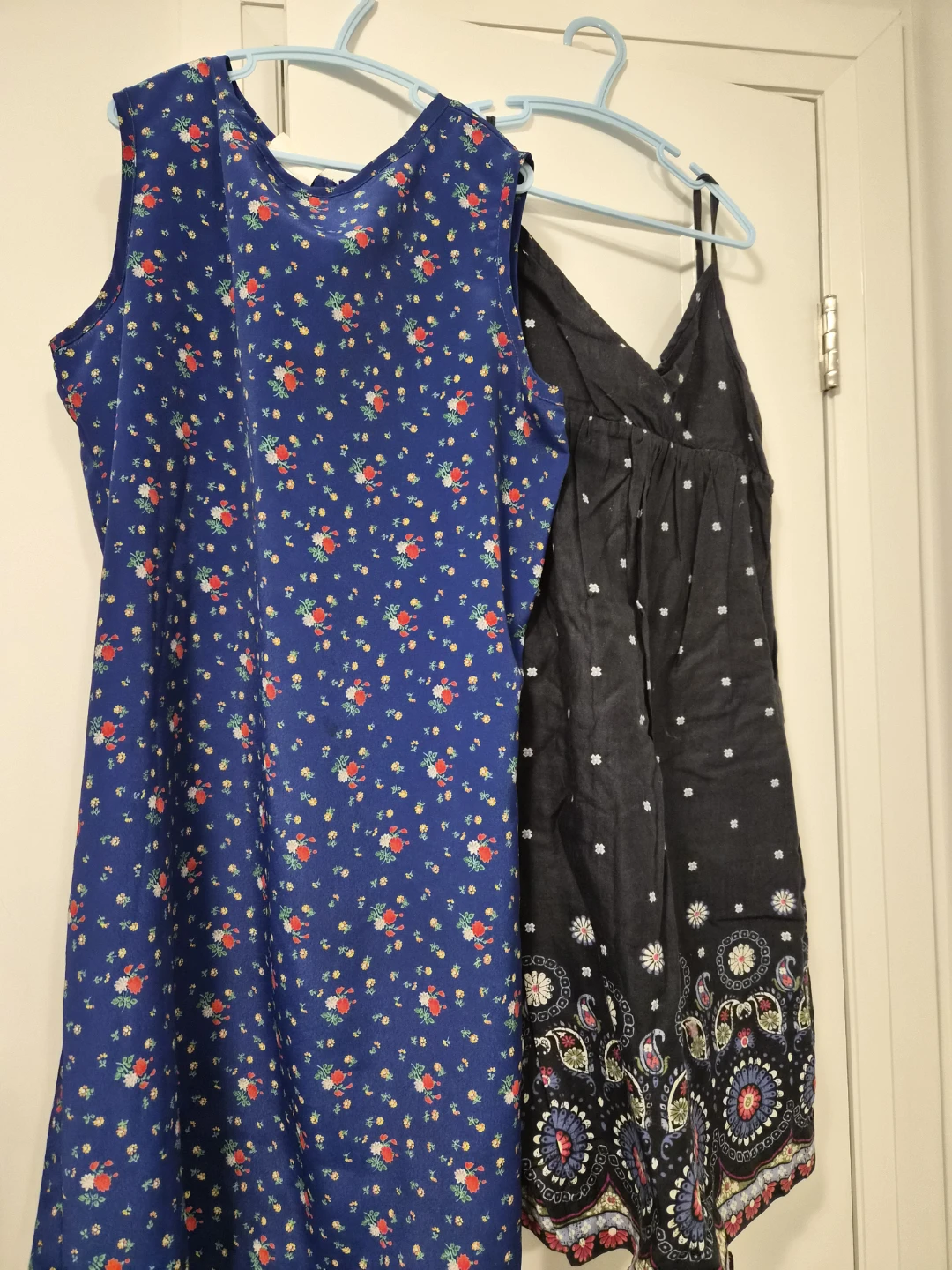 Two women's dresses: floral blue and black patterned