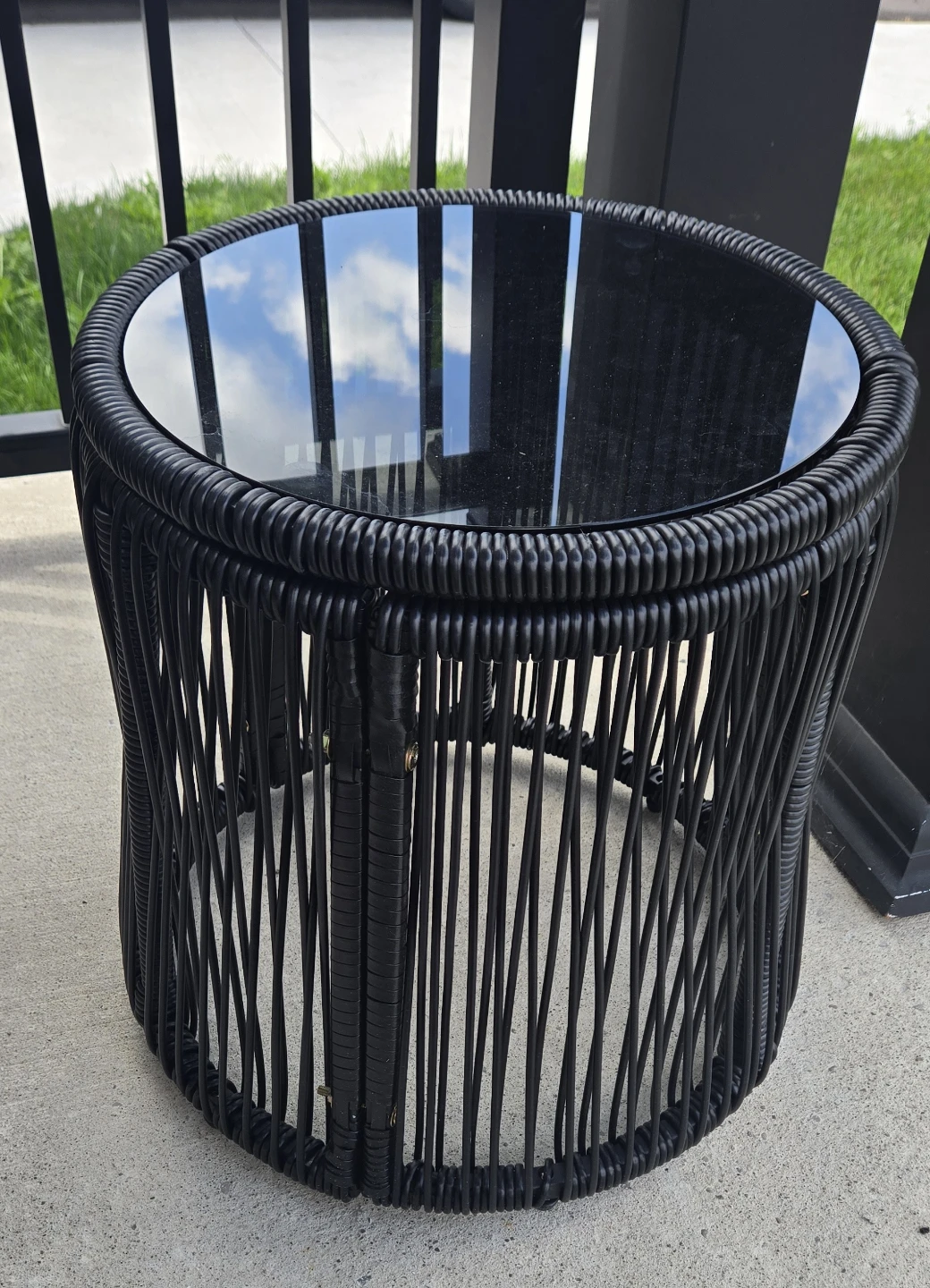 Black woven table with glass top