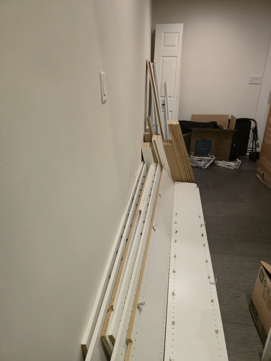 Disassembled White Shelving Units and Closet Unit