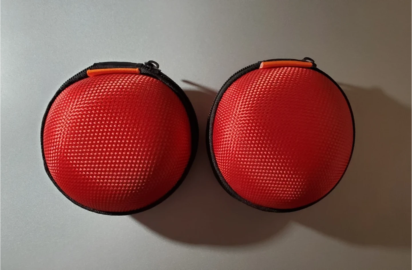 Two Red Round Zippered Cases