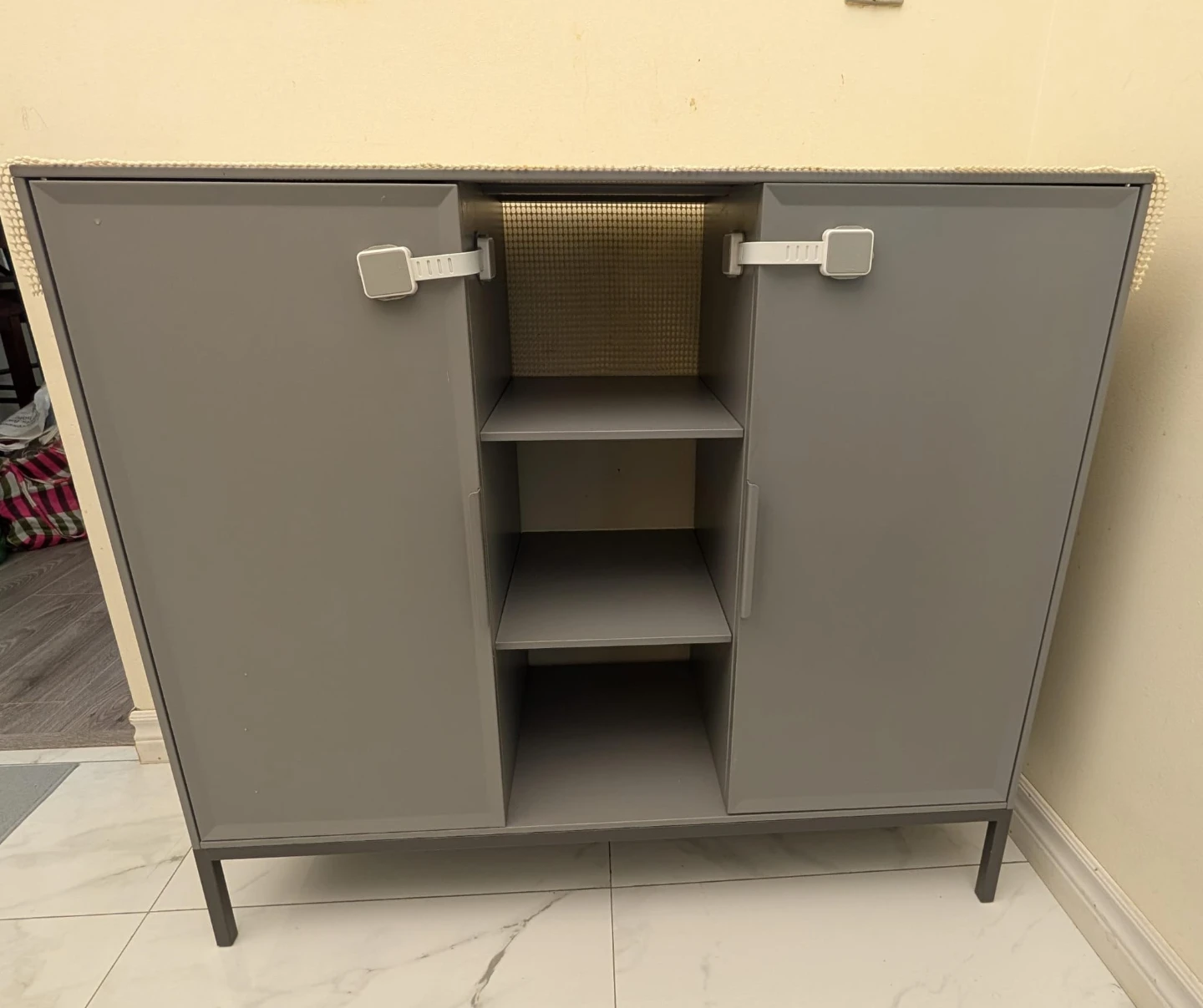 Grey storage cabinet with open shelving