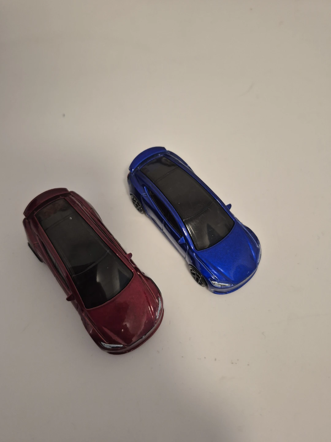 Red and blue Tesla Model S diecast toy cars