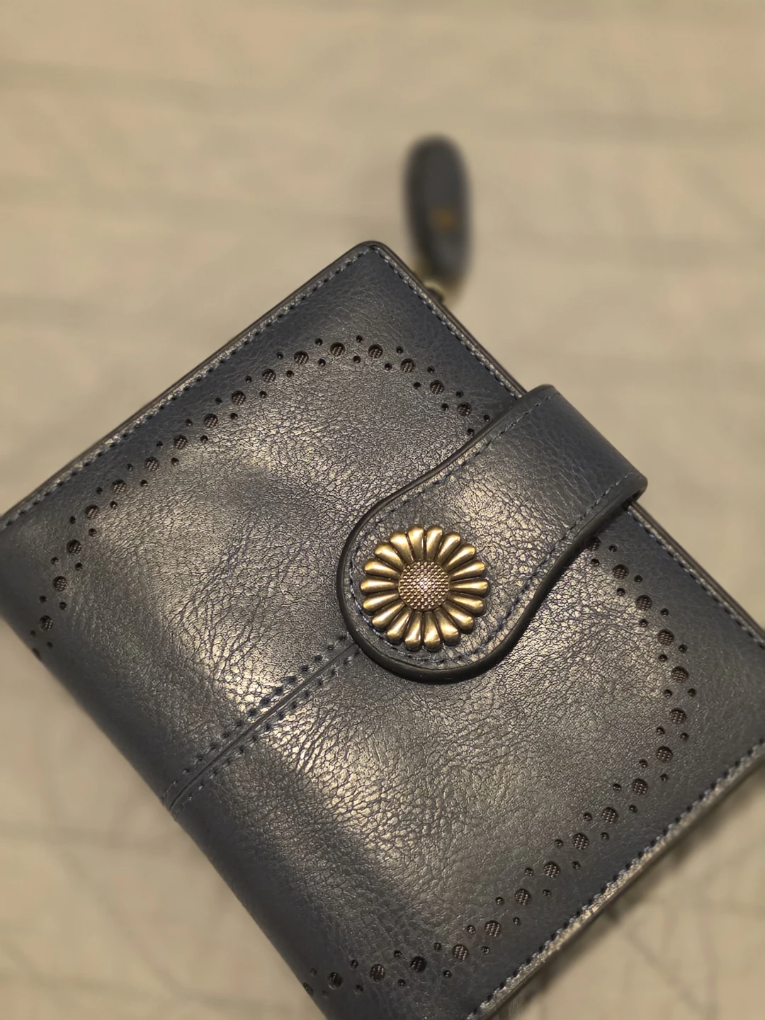 Blue bifold wallet with floral snap button