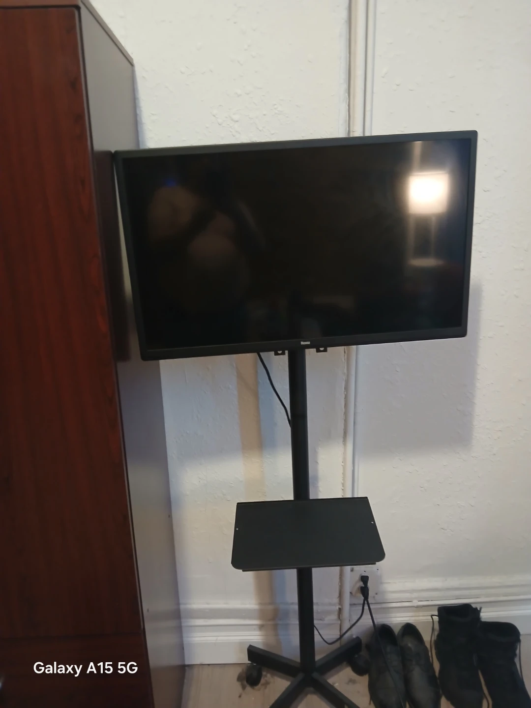 Roku Television and Black Rolling TV Stand with Tray