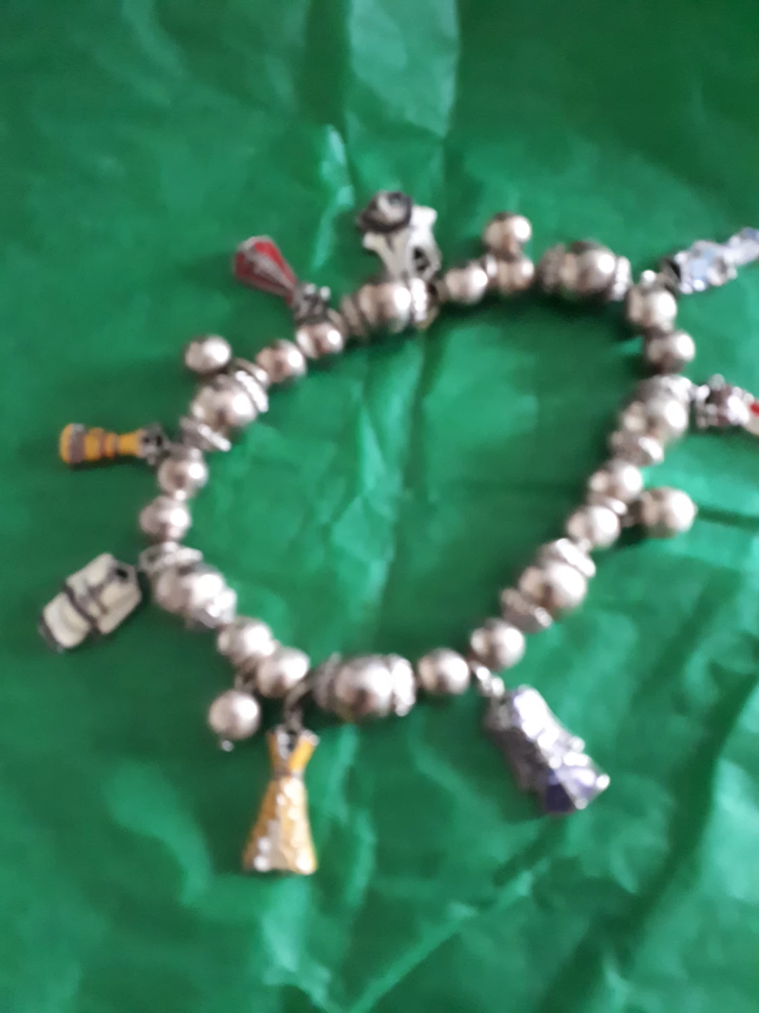 Silver-tone charm bracelet with various charms