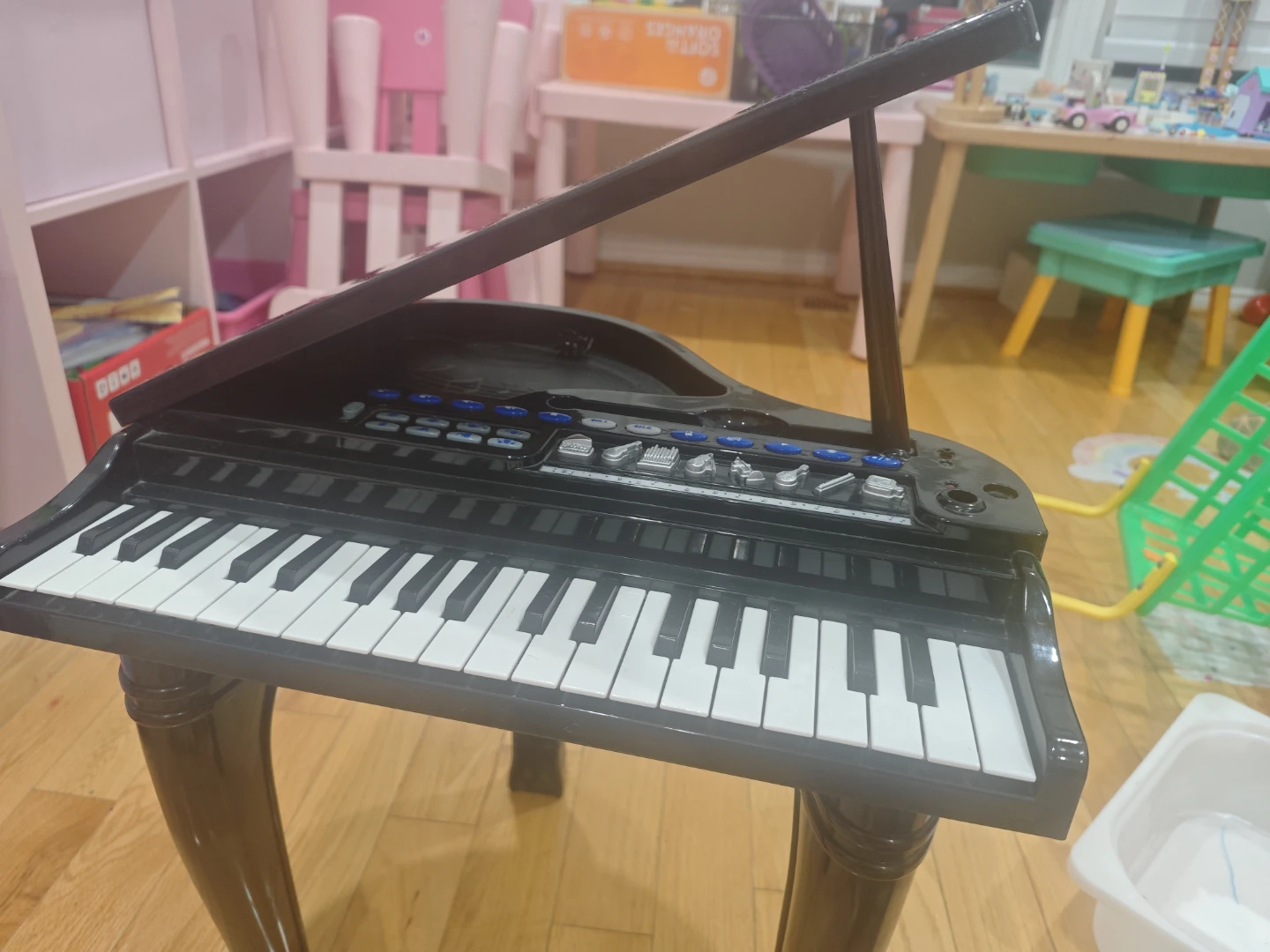 Black toy grand piano with stool
