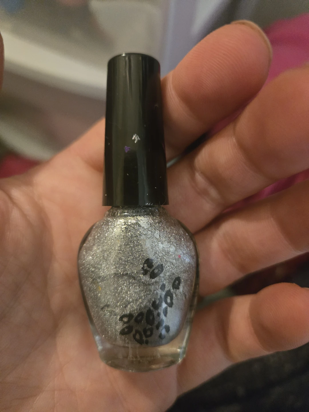Silver glitter nail polish with leopard print detail