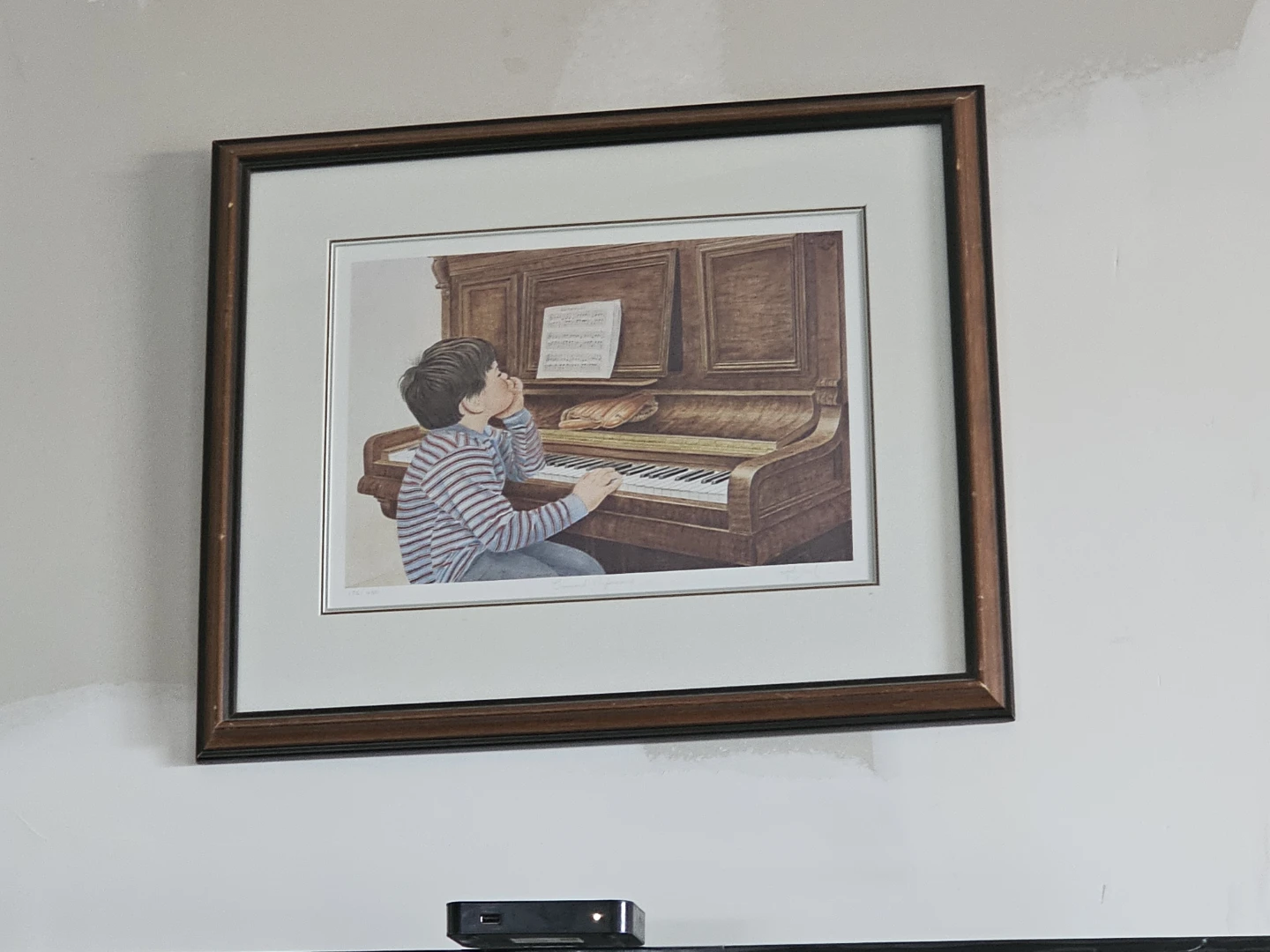 Framed Print of a Boy at a Piano