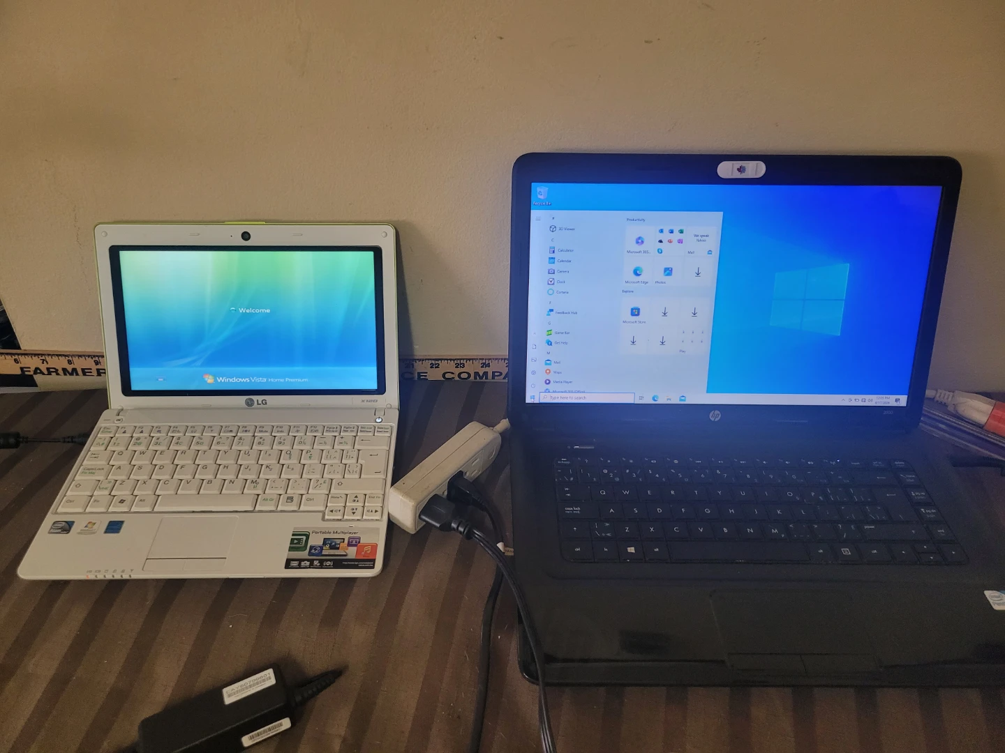 LG X120 netbook and a black HP 2000 laptop
