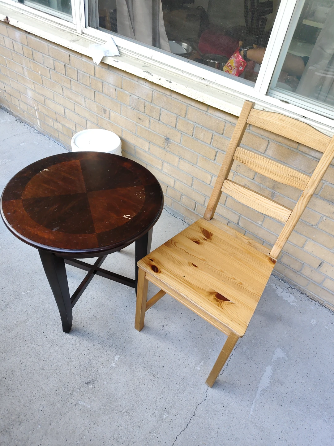 Round dark wood accent table and pine chair