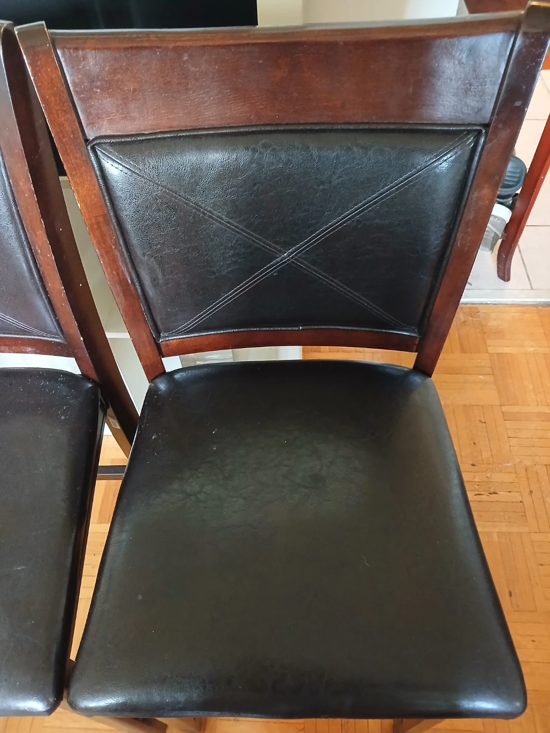 Pair of dark wood dining chairs with black faux leather seats - photo 2