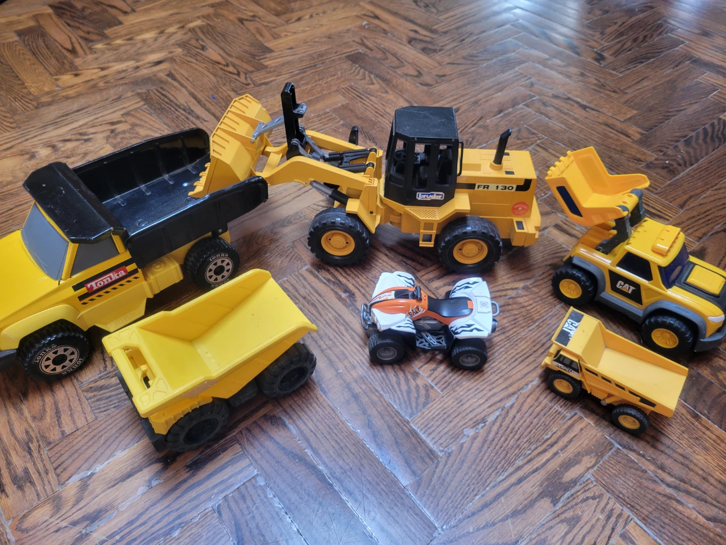 Assorted Toy Construction Vehicles and ATV
