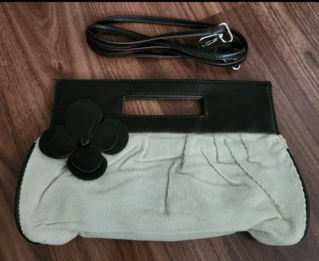 Clutch handbag with floral accent and removable strap