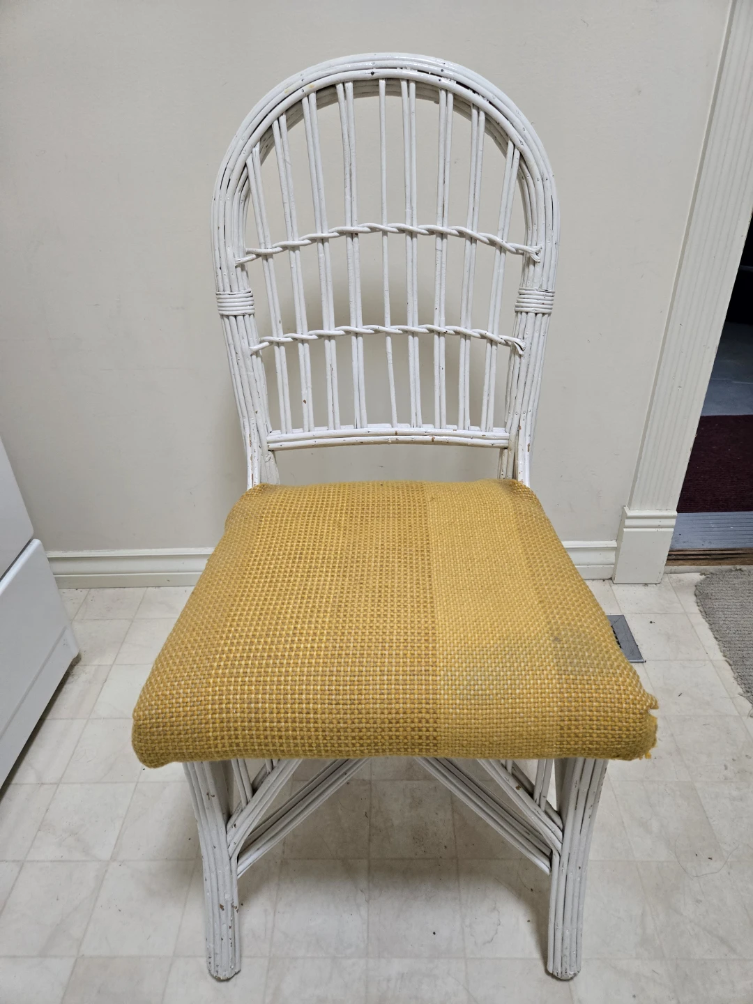 White Wicker Chair with Yellow Cushion