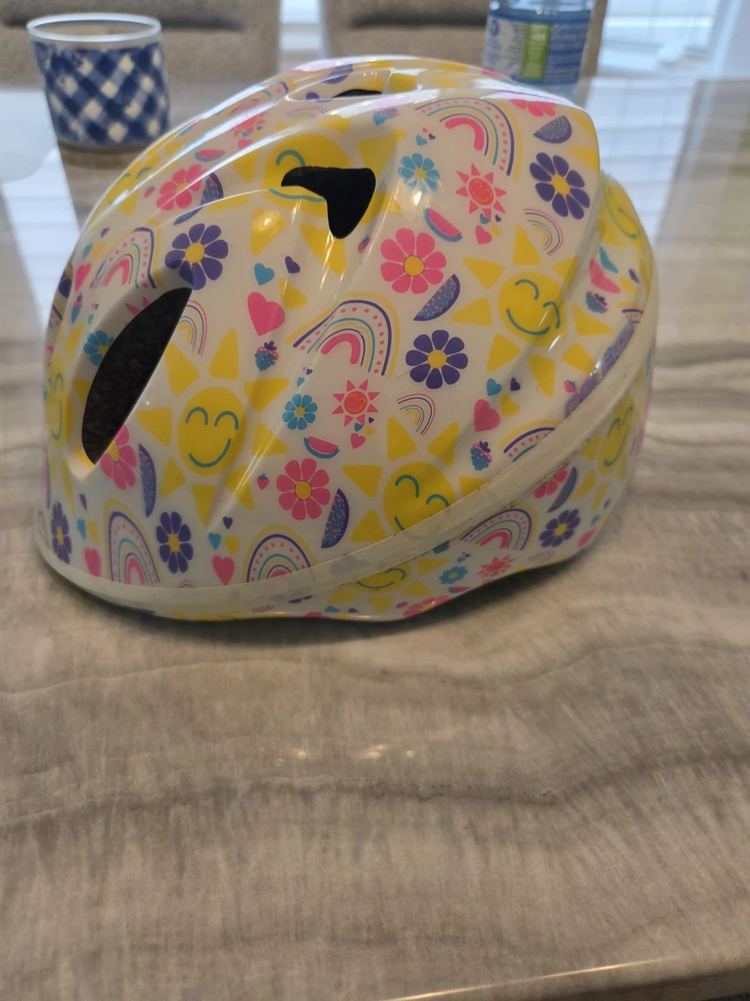 Infant bike helmet with rainbow and sun pattern