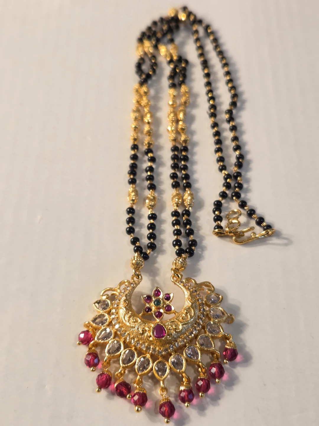Gold Necklace with Black Beads and Ruby Accents