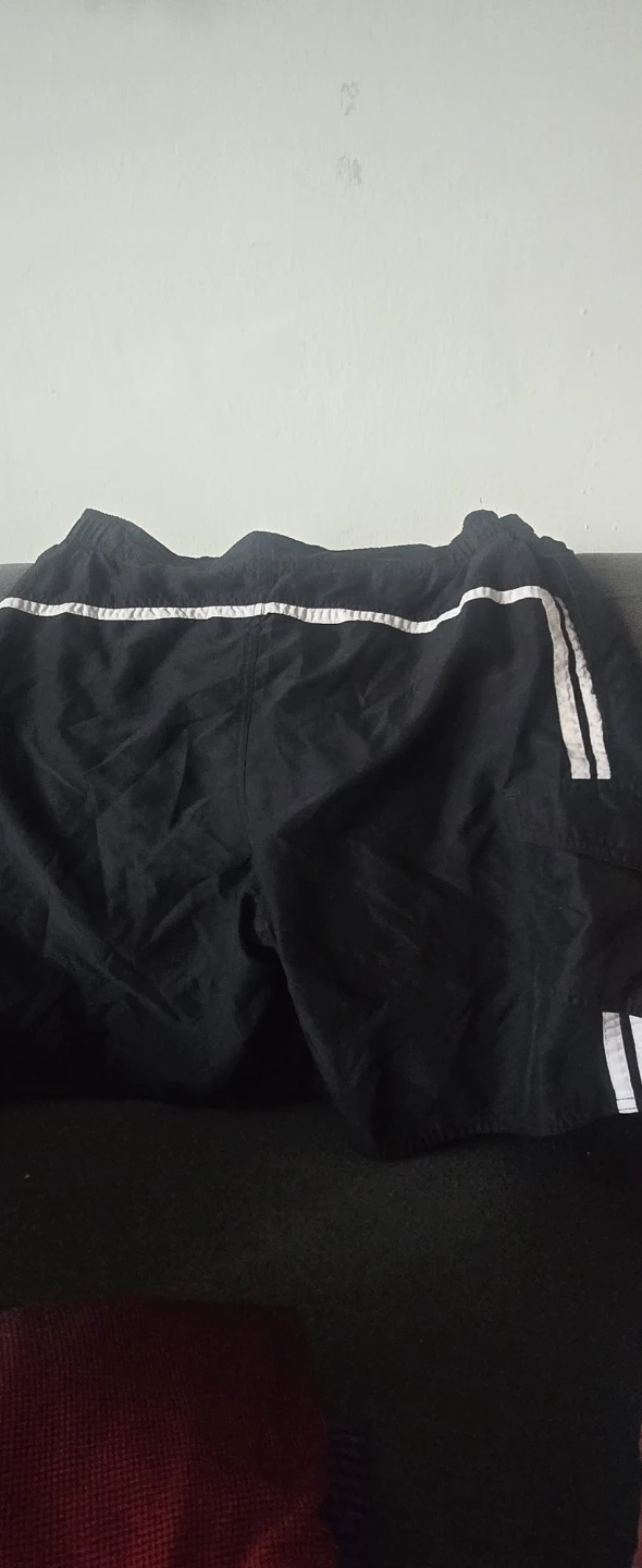 Black athletic shorts with white stripes