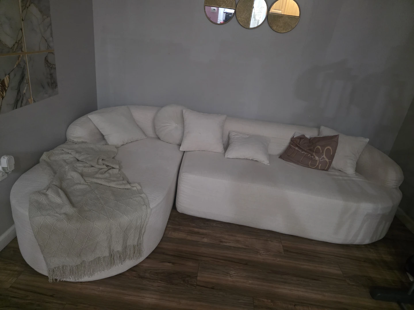 White Curved Sectional Sofa with Throw Pillows
