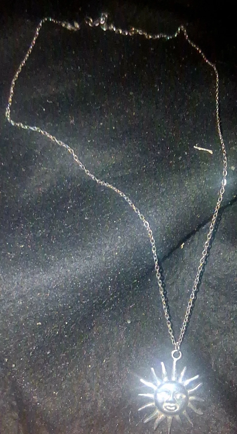 Silver toned sun pendant necklace