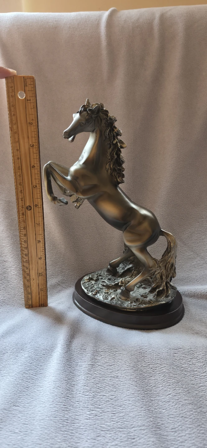 Metallic rearing horse statue on wooden base