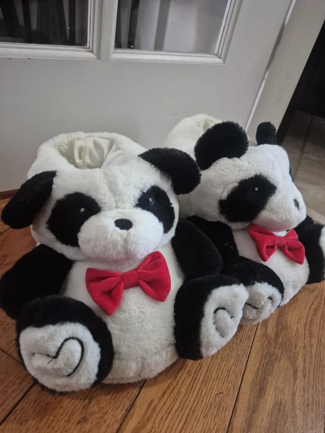 Panda plush slippers with red bows